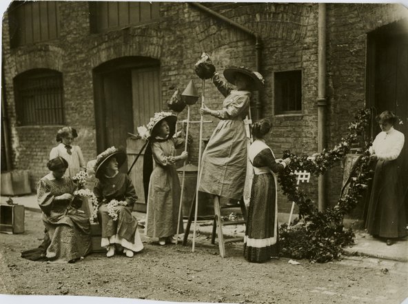 A group of women making garlands