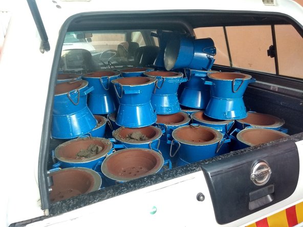 Finished cookstoves piled up in a car boot