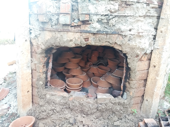 New parts for cookstoves piled up in a kiln