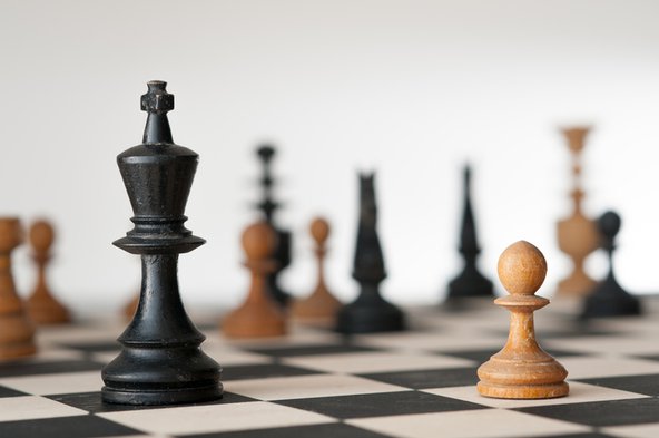 A close-up photograh of a chess board, representing the principles of game theory