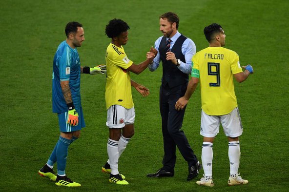 England’s coach, Gareth Southgate, shakes hands with Juan Cuadrado of the Colombian team at the end of the Colombia v England match. Image credit: Francisco Leong / AFP / Getty Images.